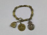 an image of a bracelet with coins and charms on a white surface