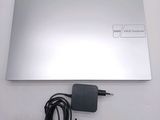 a silver laptop with a power cord attached to it