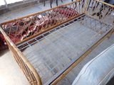 a bed that is made out of bamboo and has a metal frame