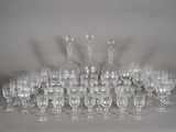 many wine glasses and decanters sitting on a table