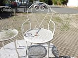 two chairs and a table on a brick patio