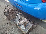a blue car that is parked on the side of the road