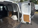 a white van with its doors open in a parking lot