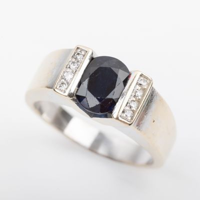 an image of a ring with a sapphire and diamonds on it