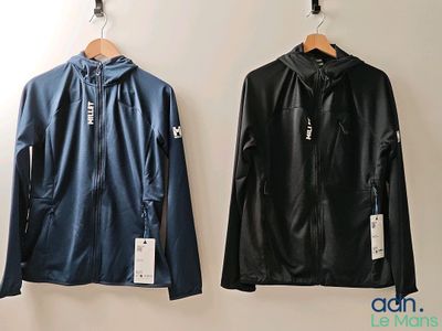 two jackets hanging up on a wall next to each other