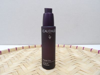 the bottle of caudale is sitting on top of a wicker basket