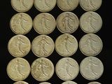 a lot of coins that are on a black surface