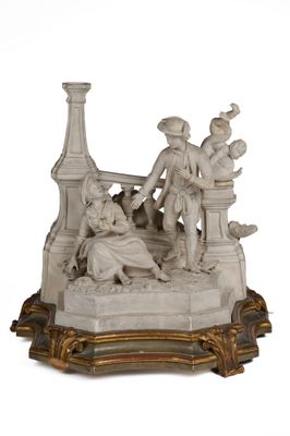 une statue représentant un homme et une femme assis sur un banc