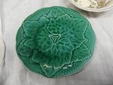a plate with a green flower on it on a table