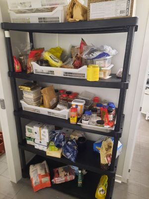 a black shelf filled with lots of food in a kitchen