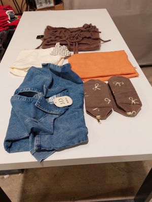 a table that has a bunch of clothes on it