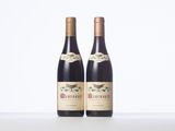two bottles of wine sitting on top of a white table