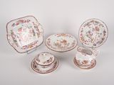 four pieces of porcelainware including a bowl, saucer, and plate