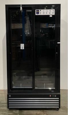 a black refrigerator with two doors open in a room