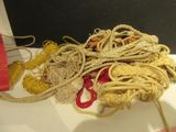 a pile of rope on a table with a pair of scissors