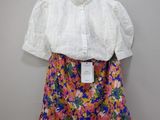 the shirt is white and has colorful flowers on it