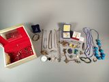 a lot of jewelry in a wooden box on a table