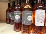 bottles of wine are lined up on a shelf in a store