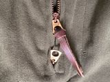 a zipper that has a small metal object in it