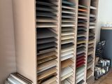 a lot of paper on the shelves in the room