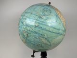 a blue and green globe sitting on a tripod stand