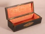 a black and orange box with a gold handle