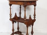 an old wooden table with a shelf on top of it