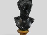 a black busturine of a woman wearing a headband