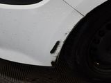 a close up of a white car with black rims
