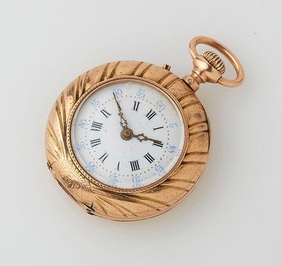 a gold pocket watch with roman numerals on it
