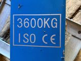 a blue box with a sign on it sitting on the ground