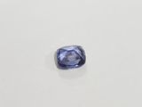 a blue sapphire stone on a white surface
