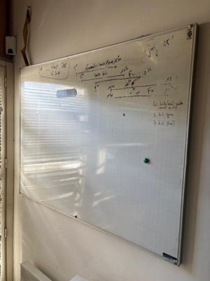 a white board on the wall in the room