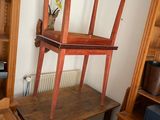 a desk with a chair and a shelf in a room