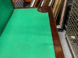 a table with a green cloth on it in a store