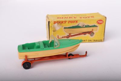 a small toy boat on a trailer with a box in the background