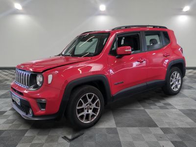 a red jeep is parked on a checkered floor in a garage