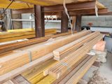 several pieces of wood are stacked on top of each other in a warehouse