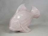 a pink ceramic fish that is sitting on a table