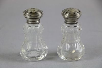 pair of clear glass salt and pepper shakers with silver tops