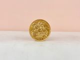 a gold coin sitting on top of a marble counter