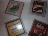 three framed pictures of shoes and shoes on display on a table