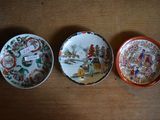 three plates are sitting on a wooden table with a tag on them