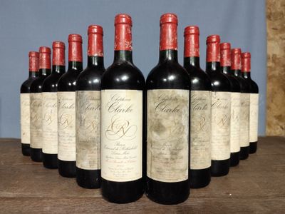 six bottles of red wine are lined up on a wooden table
