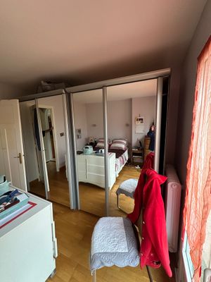a room with a bed and a chair in it