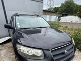a picture of a black car parked in front of a building