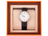 an orange box with a watch inside of it on a white background