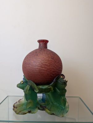 a vase sitting on top of a glass table