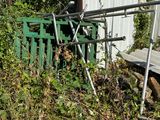 a fence that has a bunch of plants growing on it