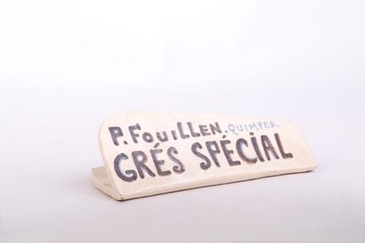 a sign that says frouillen gres special next to a cup of coffee